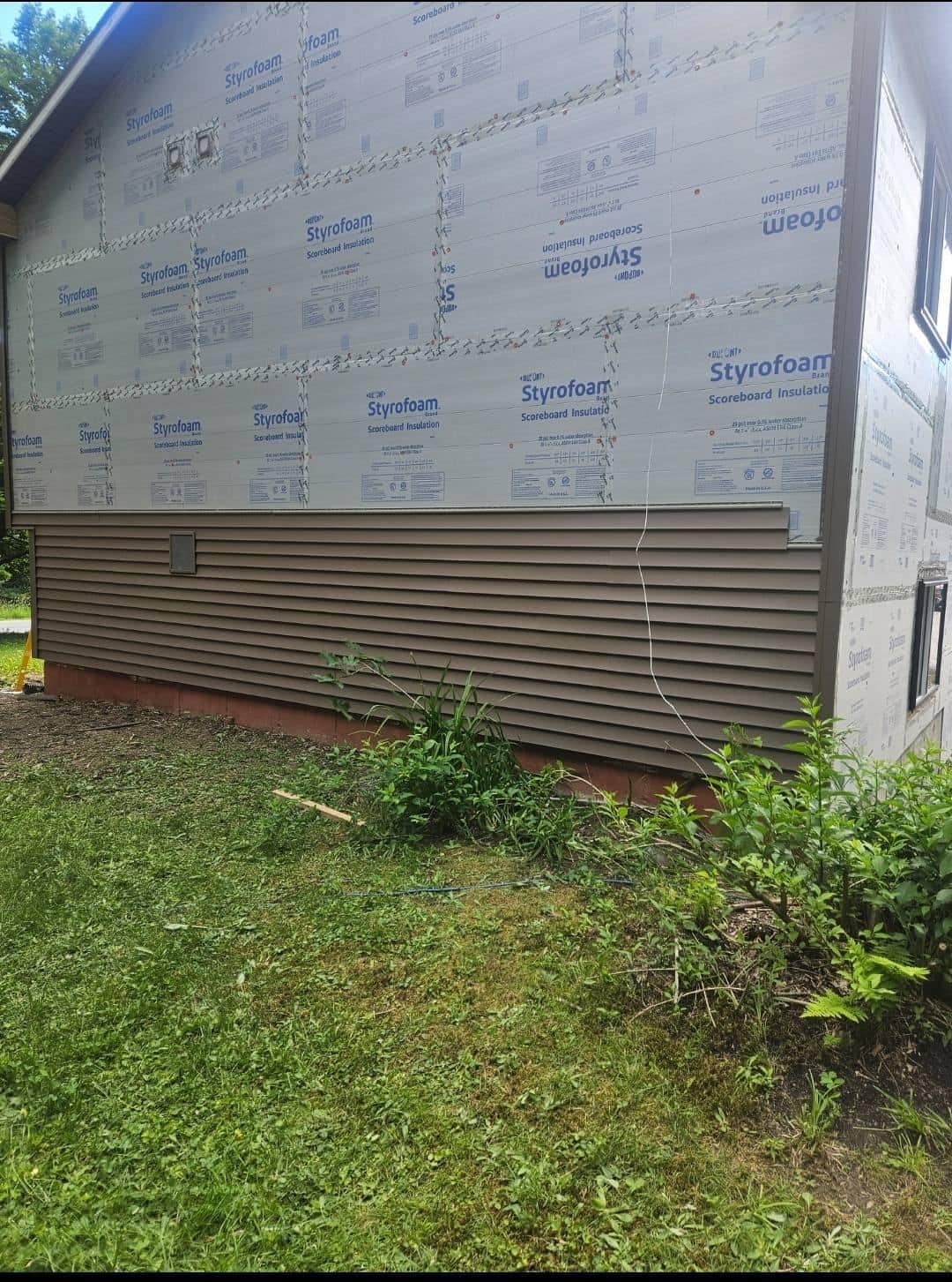 Housewrap and rigid foam